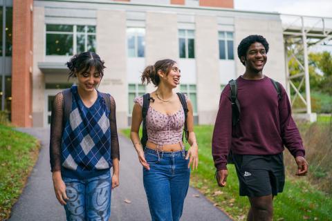 Three students walking outside talking